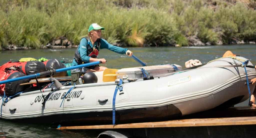 a person launches a raft off a trailer on an outward bound expedition 